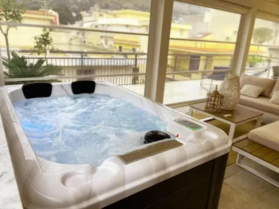 a hot tub in a living room with a large window at Al Covo dei Mori in Bagheria