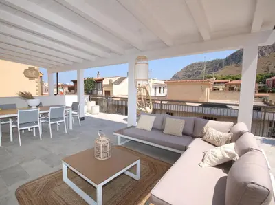 a living room with a couch and a table on a patio at Al Covo dei Mori in Bagheria