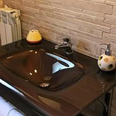 a bathroom with a black sink with a lamp on it at LE CAMERE AL CASSARO in Palermo