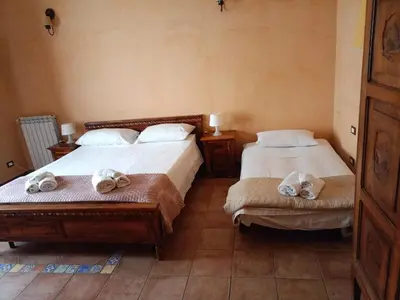 a large white bed with two towels on it at LE CAMERE AL CASSARO in Palermo