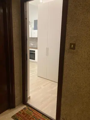 a mirror reflection of a kitchen with a door at Teatro Apartments Giardino Inglese in Palermo