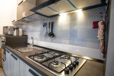 a kitchen with a stove and a sink at Sol&Luna 1909 Tourist Location in Old Town in Palermo