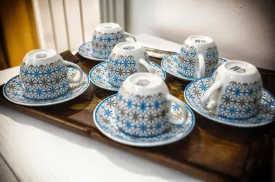 a group of blue and white cups and saucers on a table at Sol&Luna 1909 Tourist Location in Old Town in Palermo