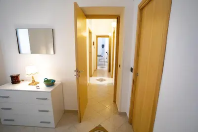 a bathroom with a white dresser and a hallway at Sol&Luna 1909 Tourist Location in Old Town in Palermo