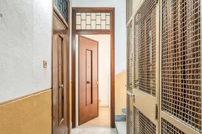 a hallway with a door and a wall of wine racks at Un balcone sull'Orto Botanico by Wonderful Italy in Palermo