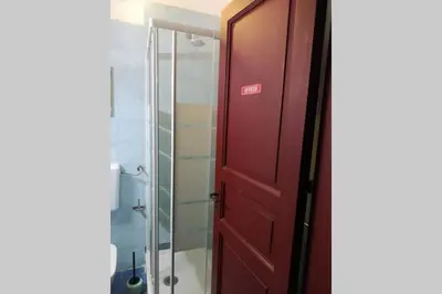 a bathroom with a red door and a shower at Fra la città storica e quella ottocentesca in Palermo