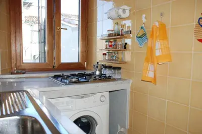 a kitchen with a washing machine and a sink at Fra la città storica e quella ottocentesca in Palermo
