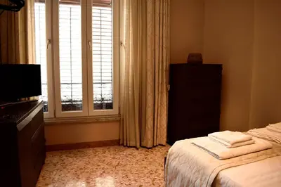 a bedroom with a bed and a window at Due Cani in Palermo