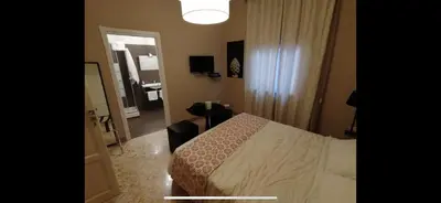 a hotel room with a bed and a mirror at Due Cani in Palermo