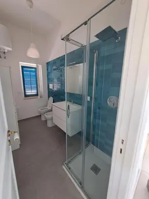 a bathroom with a glass shower and a toilet at Luxury Villa just 50 mt from the beach, 10 minutes from the airport in Carini