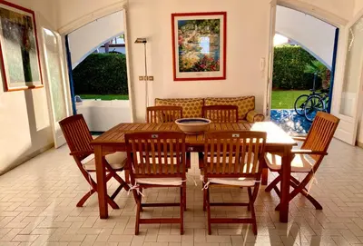 a dining room with a wooden table and chairs at Luxury Villa just 50 mt from the beach, 10 minutes from the airport in Carini