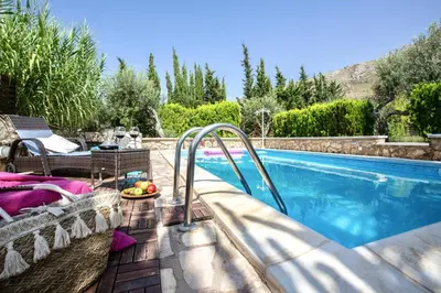 a swimming pool with a slide next to a house at Villa Chloe in Castellammare del Golfo