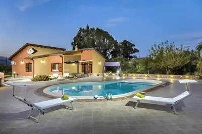 a swimming pool in front of a house at Villa Giuliana in Castellammare del Golfo