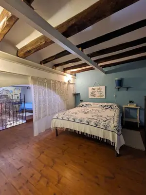 a bedroom with a bed in a room with wooden floors at Nassa Apartment in Trappeto