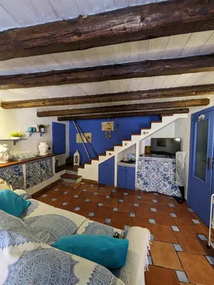 a living room with blue walls and a staircase at Nassa Apartment in Trappeto
