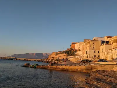 a group of buildings next to a body of water at Nassa Apartment in Trappeto