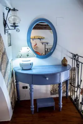 a blue dressing table with a mirror on it at Nassa Apartment in Trappeto