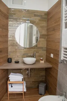 a bathroom with a sink and a mirror at Vicolo del Salto in Palermo