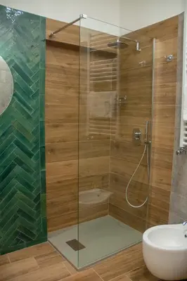 a glass shower in a bathroom with a sink at Vicolo del Salto in Palermo