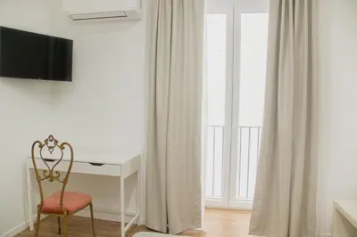 a desk and a chair in a room with a window at Vicolo del Salto in Palermo
