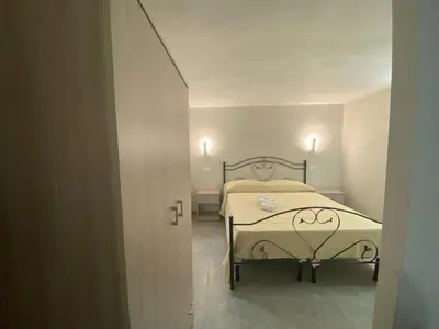 a bedroom with a bed in a small room at Case Vacanze Seggettieri in Palermo