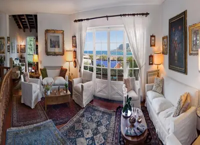 a living room with white furniture and a large window at Il Glicine sul Golfo in Mondello