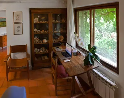 a room with a desk with a laptop and a window at Il Glicine sul Golfo in Mondello