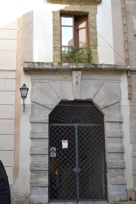 a building with a gate and a window at Home Resuttano in Palermo