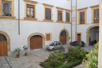 two cars parked in front of a building at Home Resuttano in Palermo