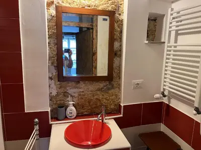 a bathroom with a red sink and a mirror at FraLePorte Vintage Apartment in Palermo
