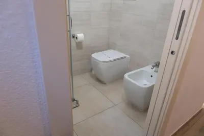 a bathroom with a toilet and a sink at Barlaman Luxury Rooms in Palermo