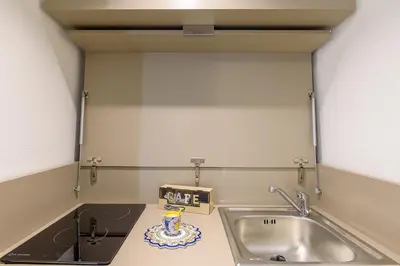 a kitchen with a sink and a counter top at Barlaman Luxury Rooms in Palermo