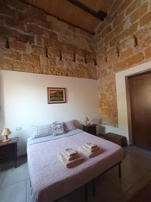 a bedroom with a bed with two towels on it at ZyZ Apartments La Kalsa in Palermo