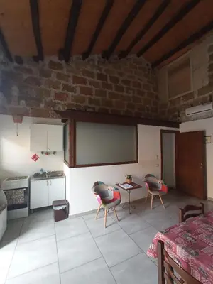 a kitchen with two chairs and a table in a room at ZyZ Apartments La Kalsa in Palermo