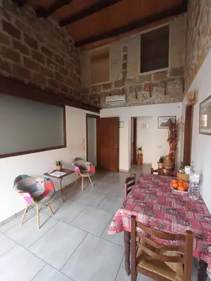 a room with a table and chairs and a projection screen at ZyZ Apartments La Kalsa in Palermo