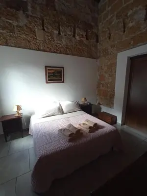 a bedroom with a bed with towels on it at ZyZ Apartments La Kalsa in Palermo