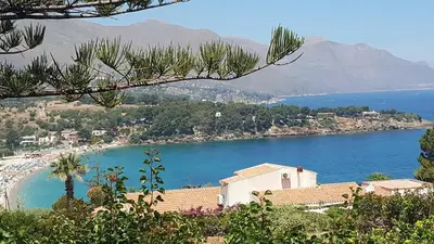 a view of a beach and a body of water at Scopello sul mare 1 in Castellammare del Golfo