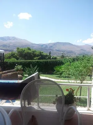 a white chair sitting on a balcony with a view at Scopello sul mare 1 in Castellammare del Golfo