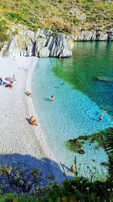 a group of people swimming in a body of water at Scopello sul mare 1 in Castellammare del Golfo