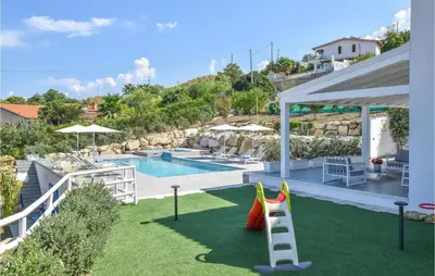 a backyard with a pool and a play equipment at Cozy Home In Partinico With Wifi in Partinico