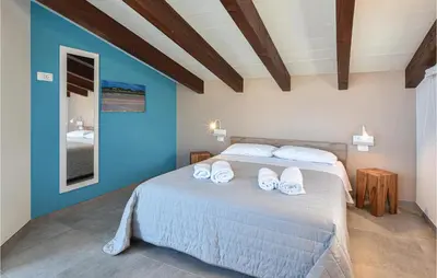 a bedroom with a bed with two towels on it at Cozy Home In Partinico With Wifi in Partinico