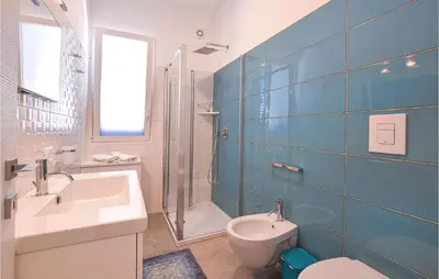 a bathroom with a sink and a toilet and a shower at Cozy Home In Partinico With Wifi in Partinico