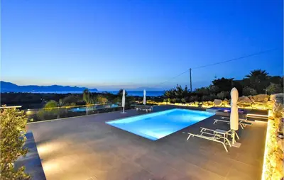 a swimming pool with lounge chairs and a view of the mountains at Cozy Home In Partinico With Wifi in Partinico