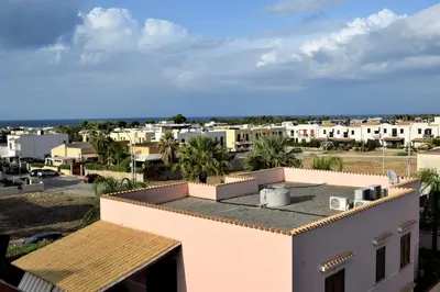 a view of a city from the roof of a house at Pozzo Antico Apartments in San Vito lo Capo