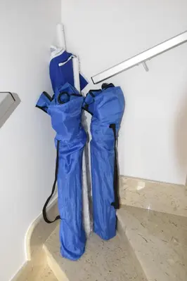 two blue bags are hanging on a wall at Pozzo Antico Apartments in San Vito lo Capo