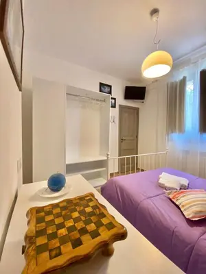 a room with a chessboard on a table and a bed at Villa Romitello con Piscina Total Relax in Borgetto