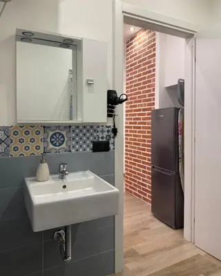 a bathroom with a sink and a refrigerator at Dimora Palermo with private pool in Palermo