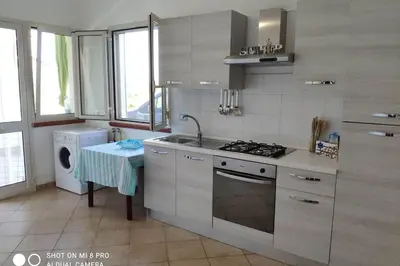 a kitchen with a sink and a stove top oven at Sul mare con spiaggetta privata vicino a Cefalù. in Buonfornello