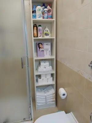 a bathroom with a shower and a toilet and towels at Sul mare con spiaggetta privata vicino a Cefalù. in Buonfornello