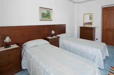 a bedroom with two beds and two dressers at Residence Il Capo in Palermo